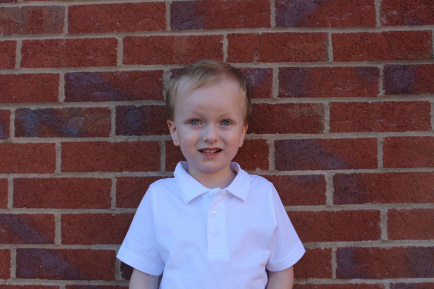 A 4 year old in his school t shirt