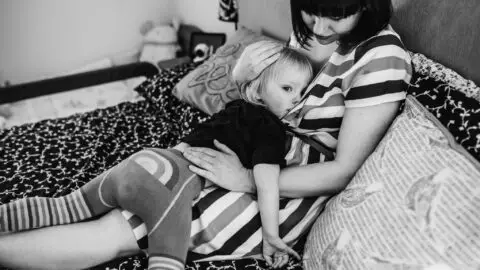 Mother breastfeeding a toddler