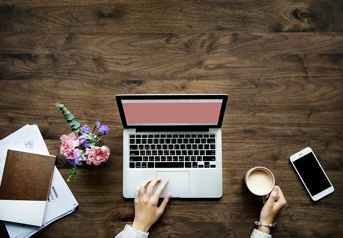 Flowers, laptop and cup of coffee