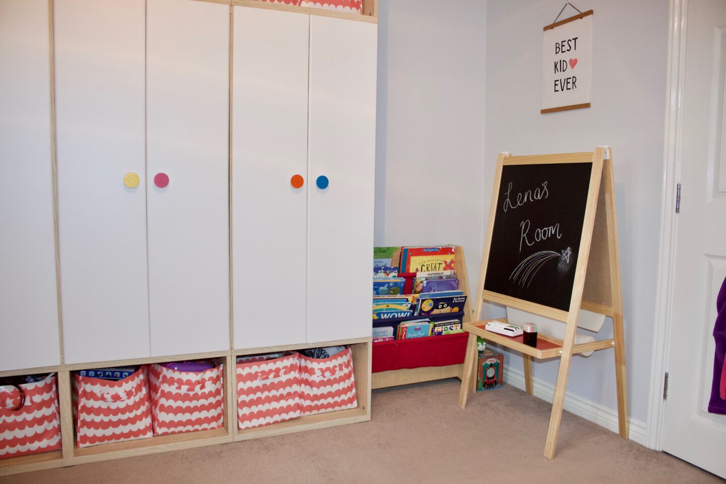 A child's bedroom with a bookshelf and an art easel