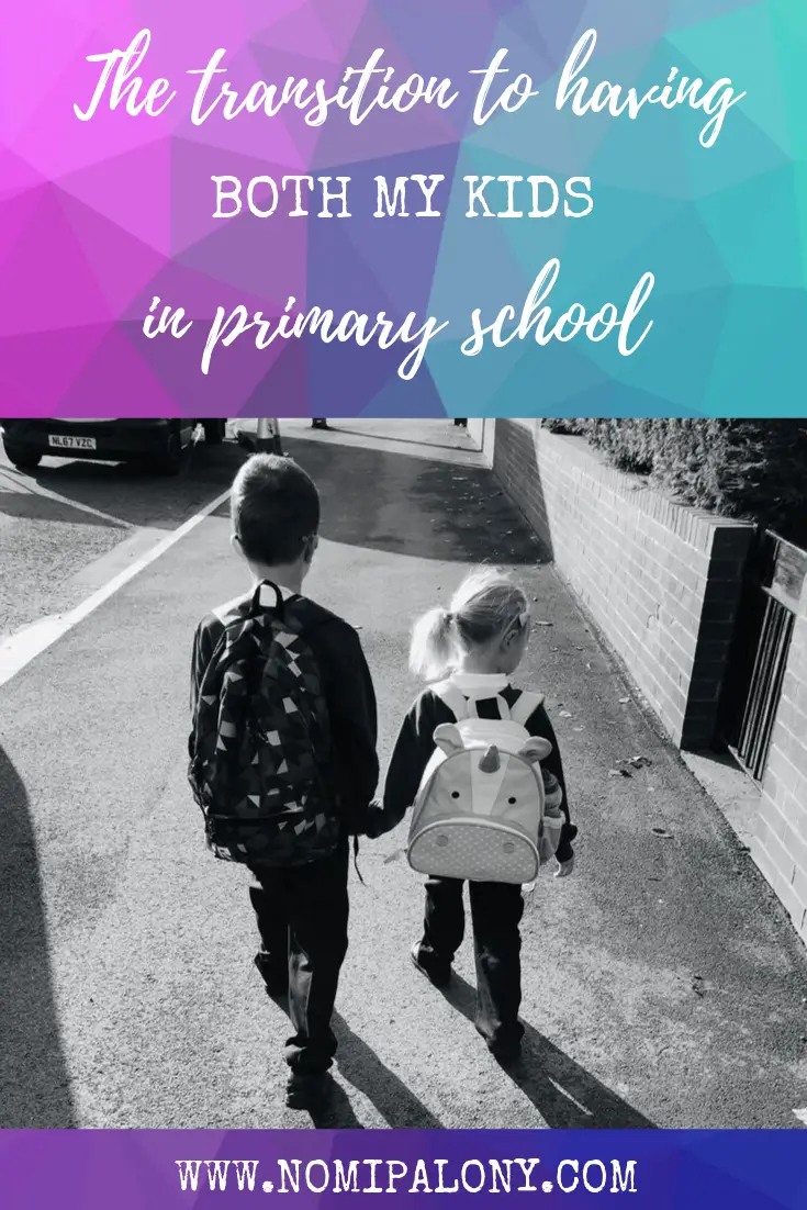 Two children walking to school together holding hands 