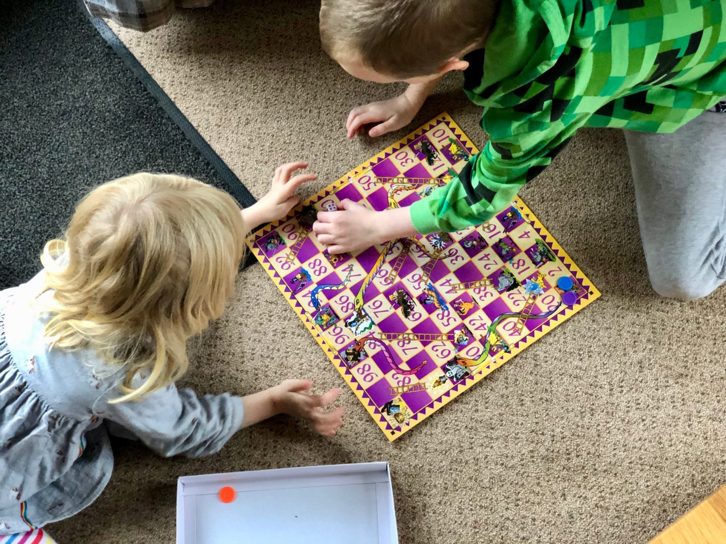 AD: Landal Sandybrook Peak District family review - a relaxing autumnal long weekend break. Kids playing snakes and ladders.