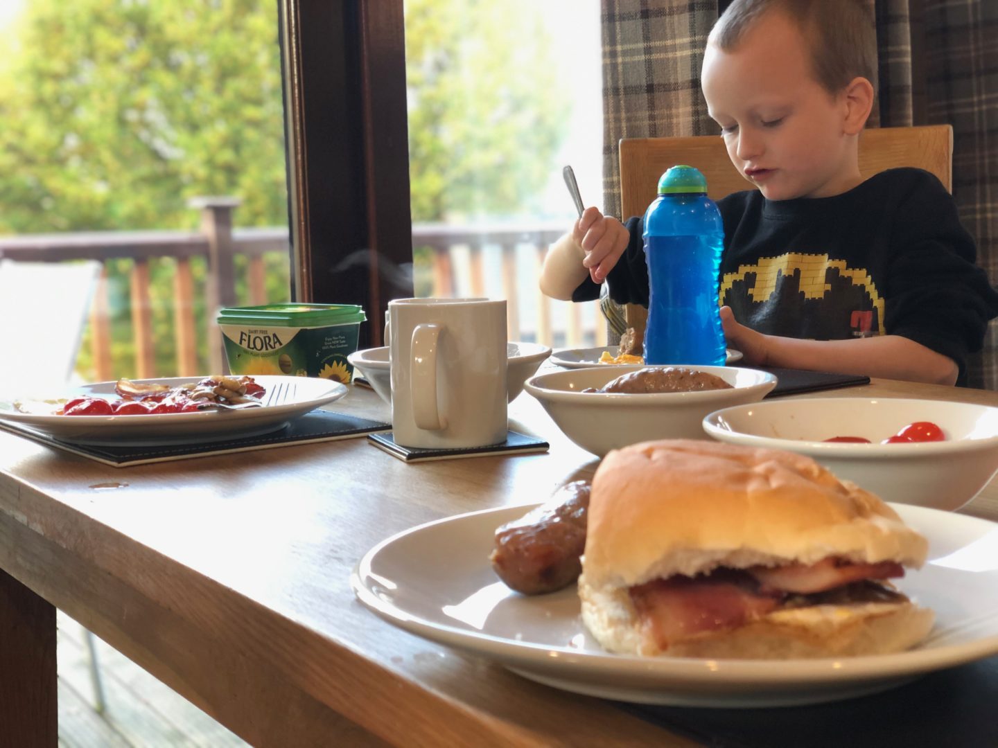 AD: Landal Sandybrook Peak District family review - a relaxing autumnal long weekend break. My son eating his breakfast in the kitchen.