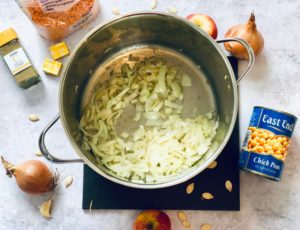 One pot pumpkin soup with apple, lentils and chickpeas - softening the onion and garlic