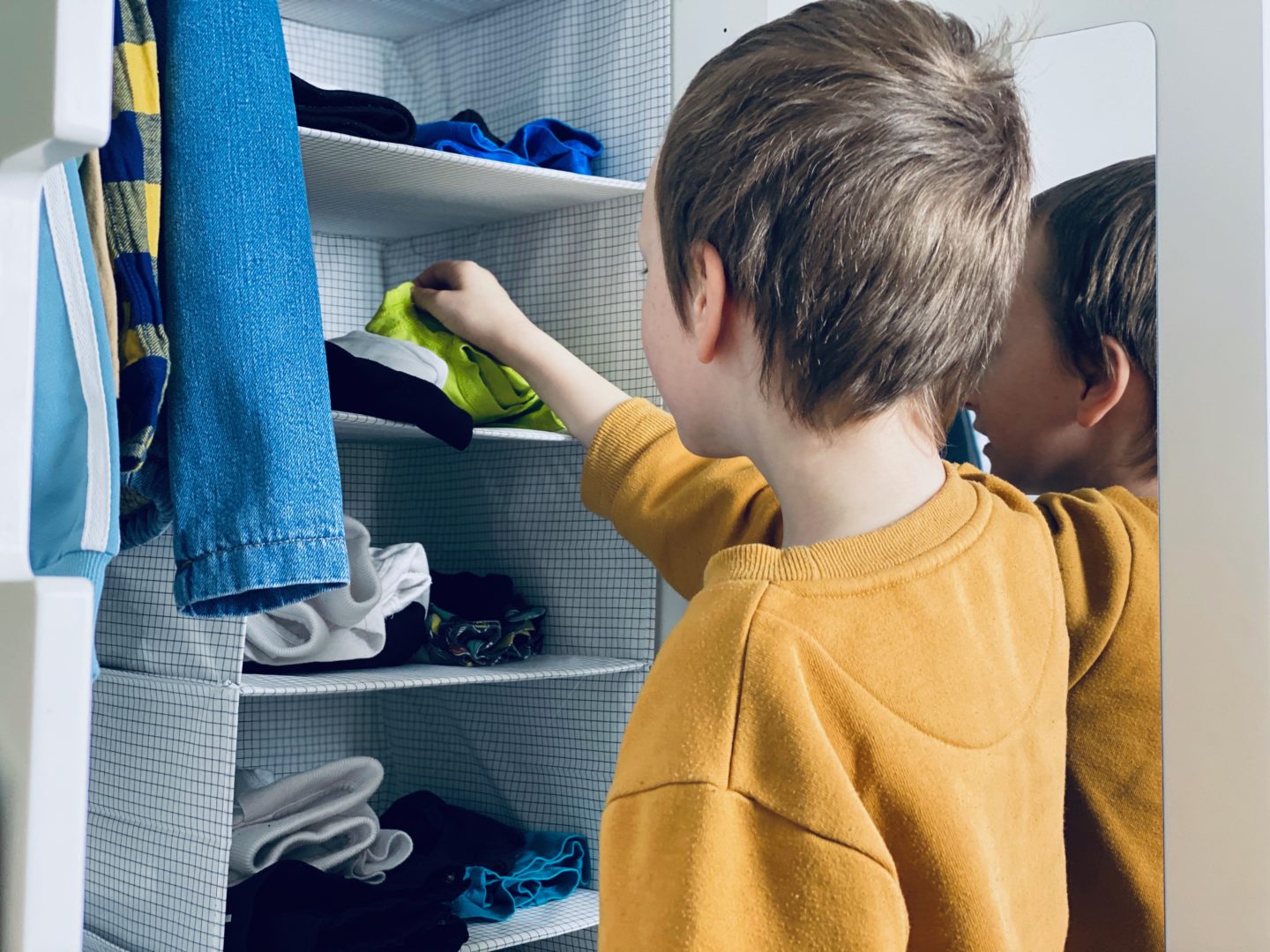 AD: Taking back control of mornings for only £51.75 with IKEA organisation hacks. 8 year old using hanging organiser to get dressed. 