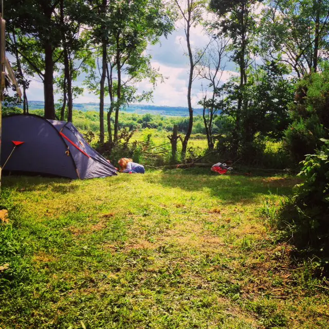 A child and a tent in the woods 