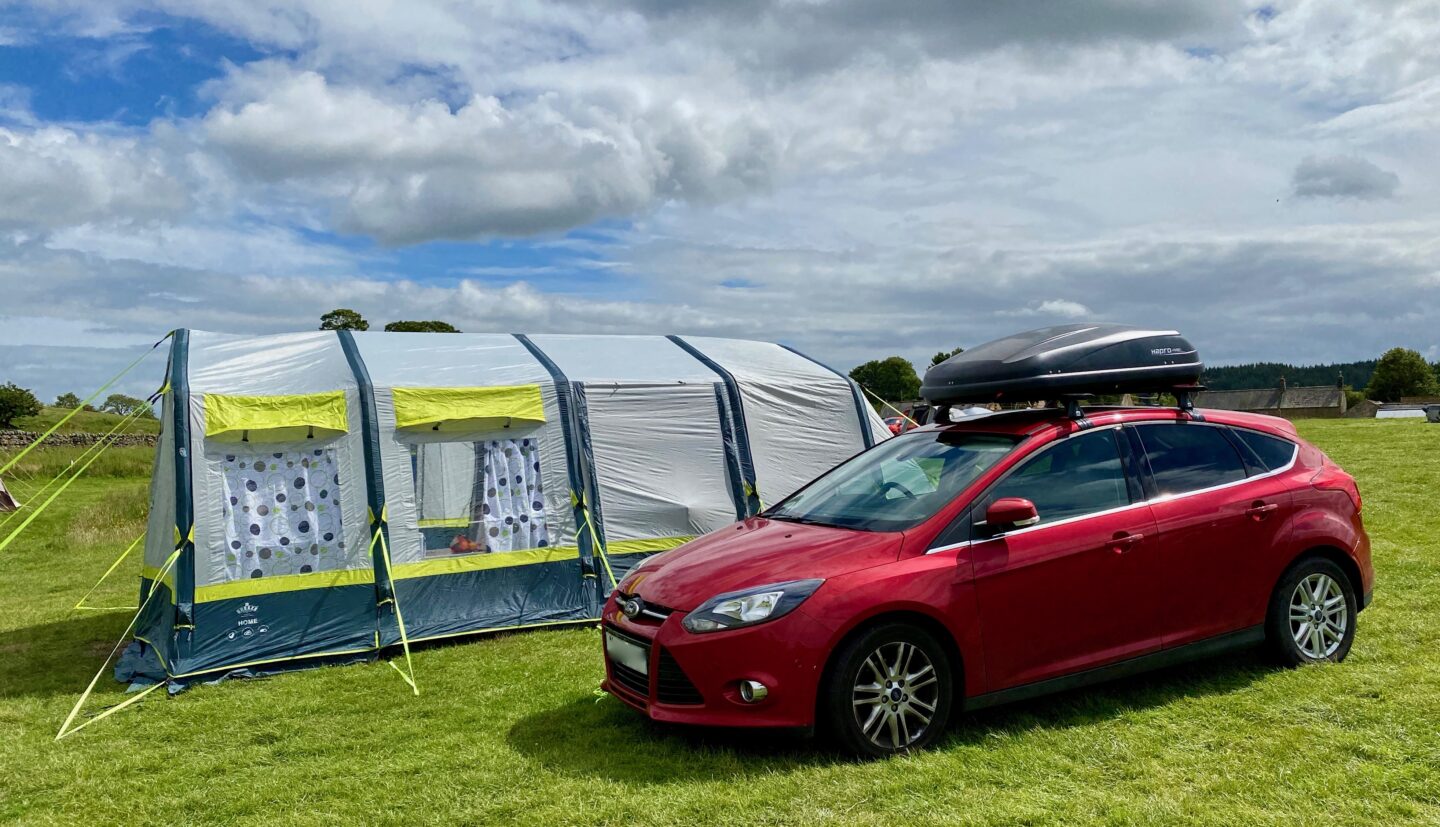 The OLPRO Home tent next to a Ford Focus 