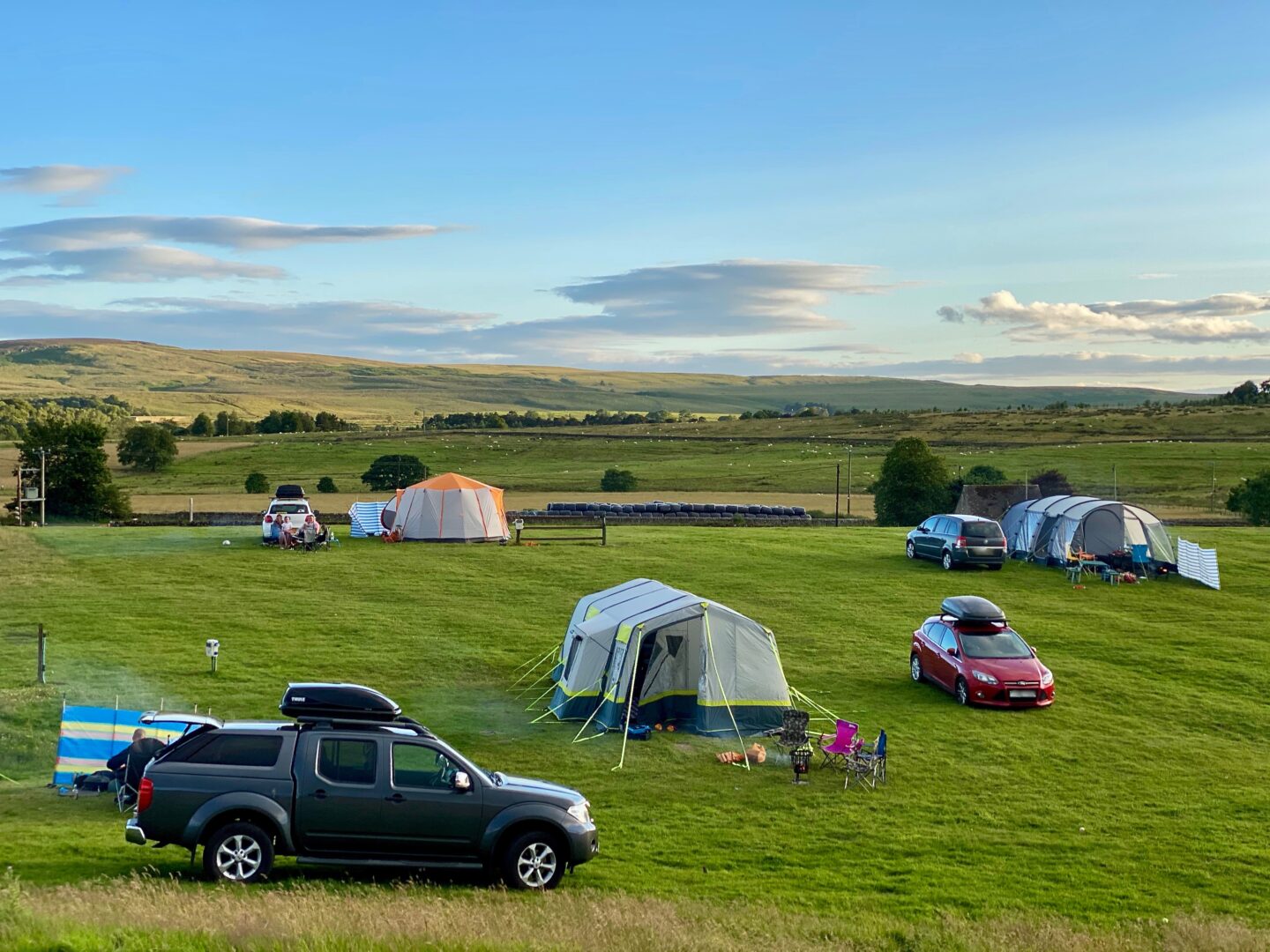 The Boe Rigg campsite - 3 tents and cars in a field