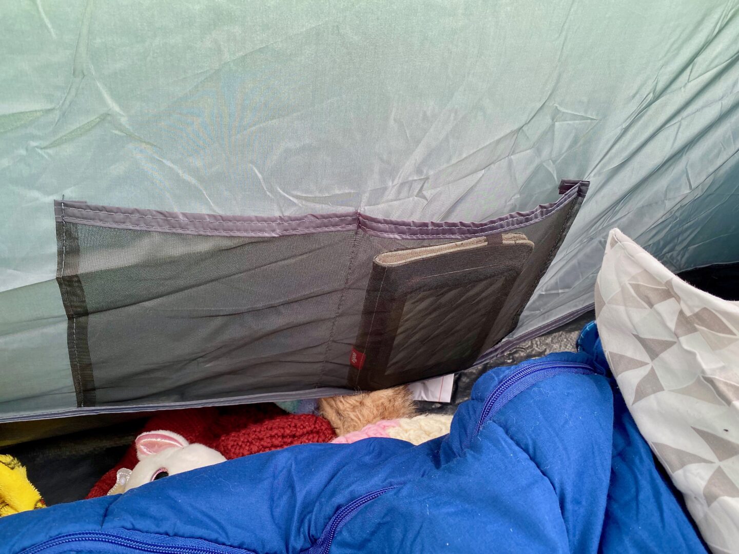 Pockets in the bedroom of the tent holding a kindle