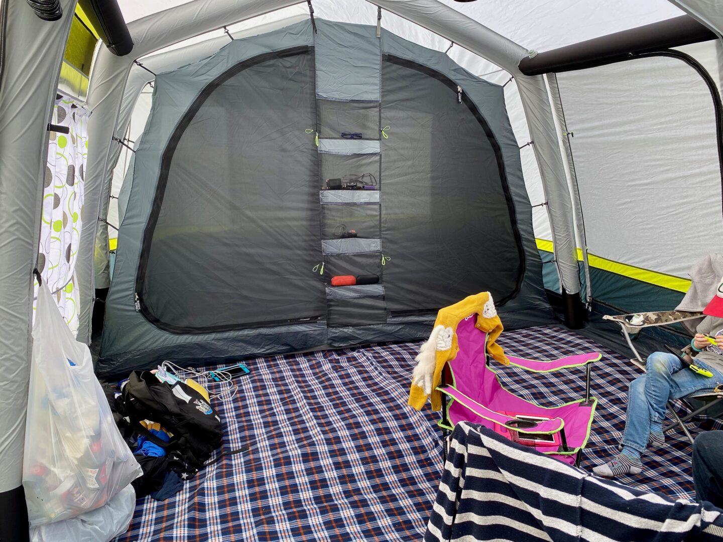 The inside of a tent with storage pockets and a tent carpet 