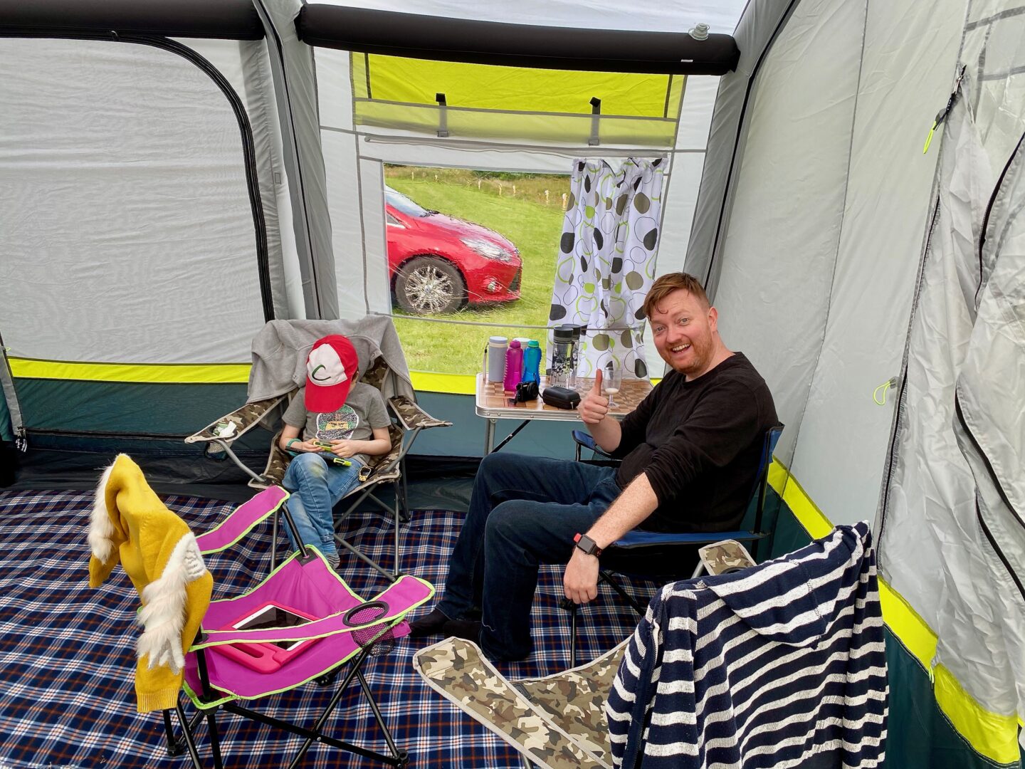 A father and son relaxing in the OLPRO Home tent