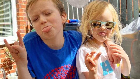 Boy and girl posing for a photo in the sun