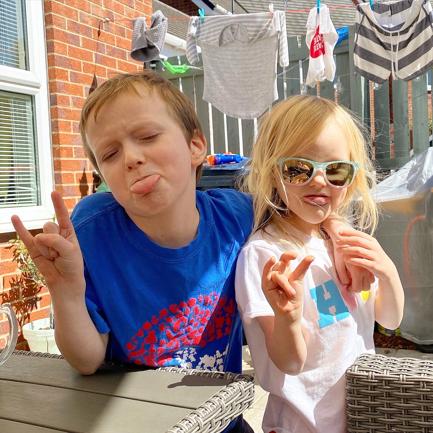 Boy and girl posing for a photo in the sun