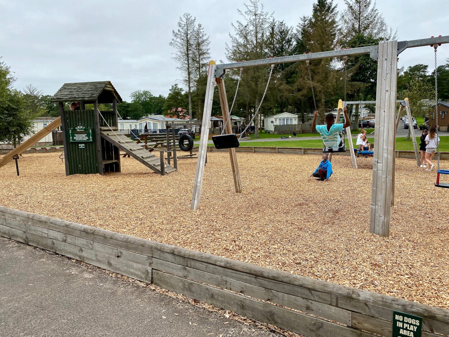 Children playing on swings in a play park