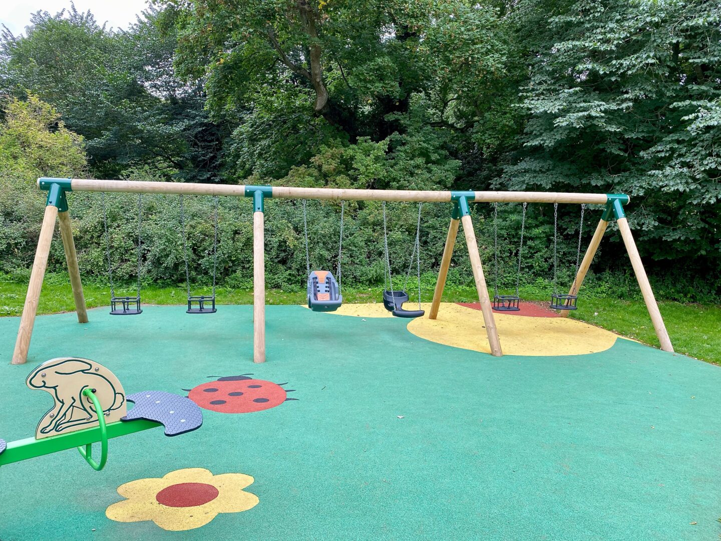 A swingset showing some accessible seating