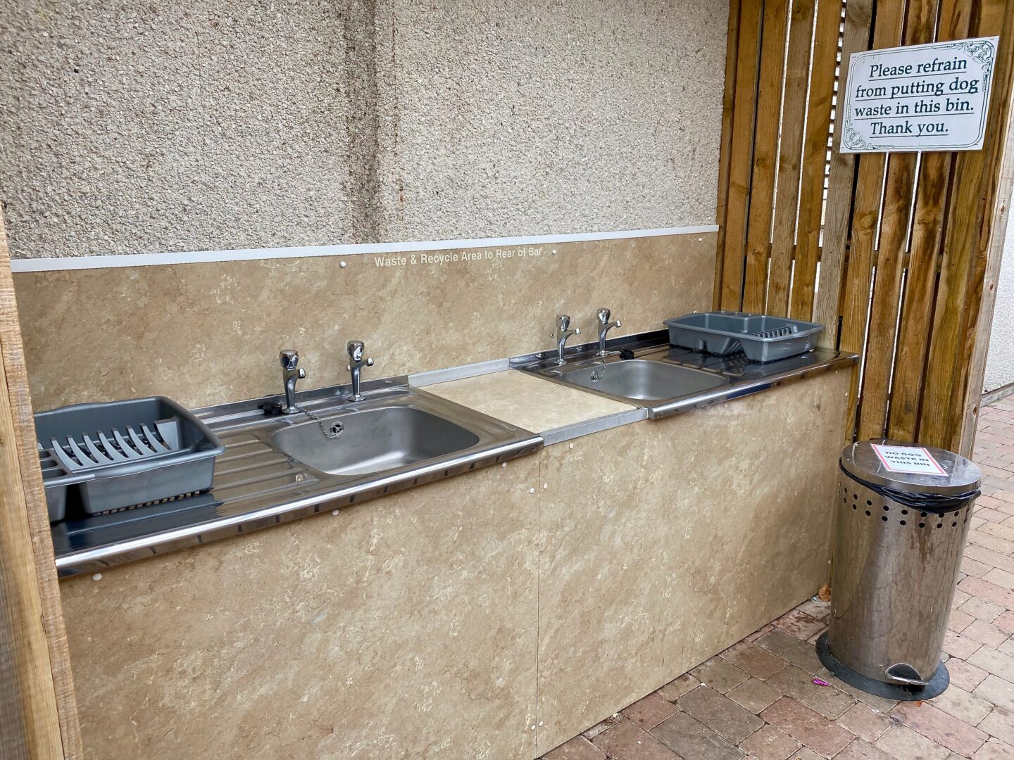 The dishwashing facility of two sinks with two drainers and a bin. 