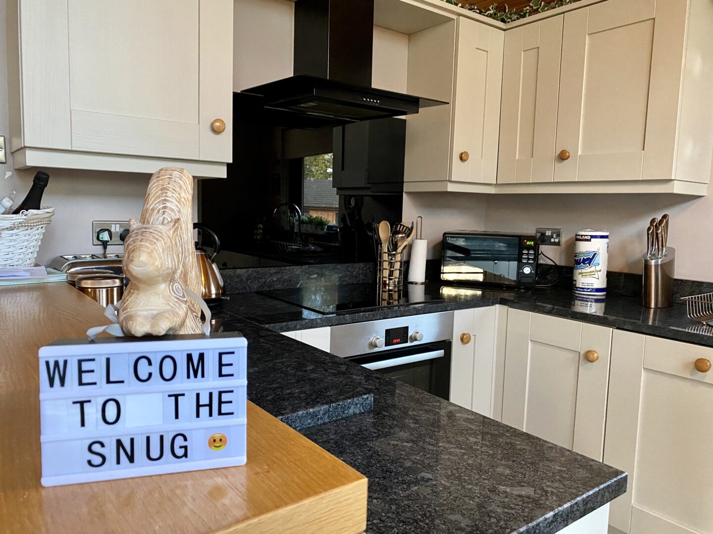 Kitchen with a small sign that says welcome to the snug