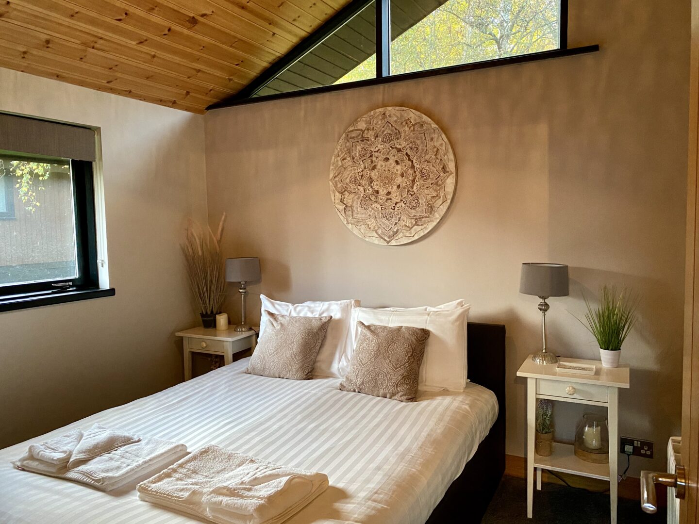 Master bedroom with fresh towels laid out on it