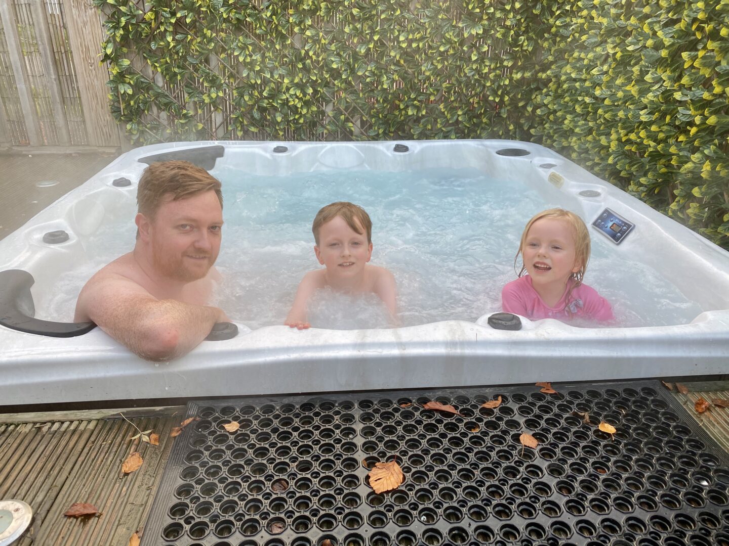 Father, boy and girl in a hot tub