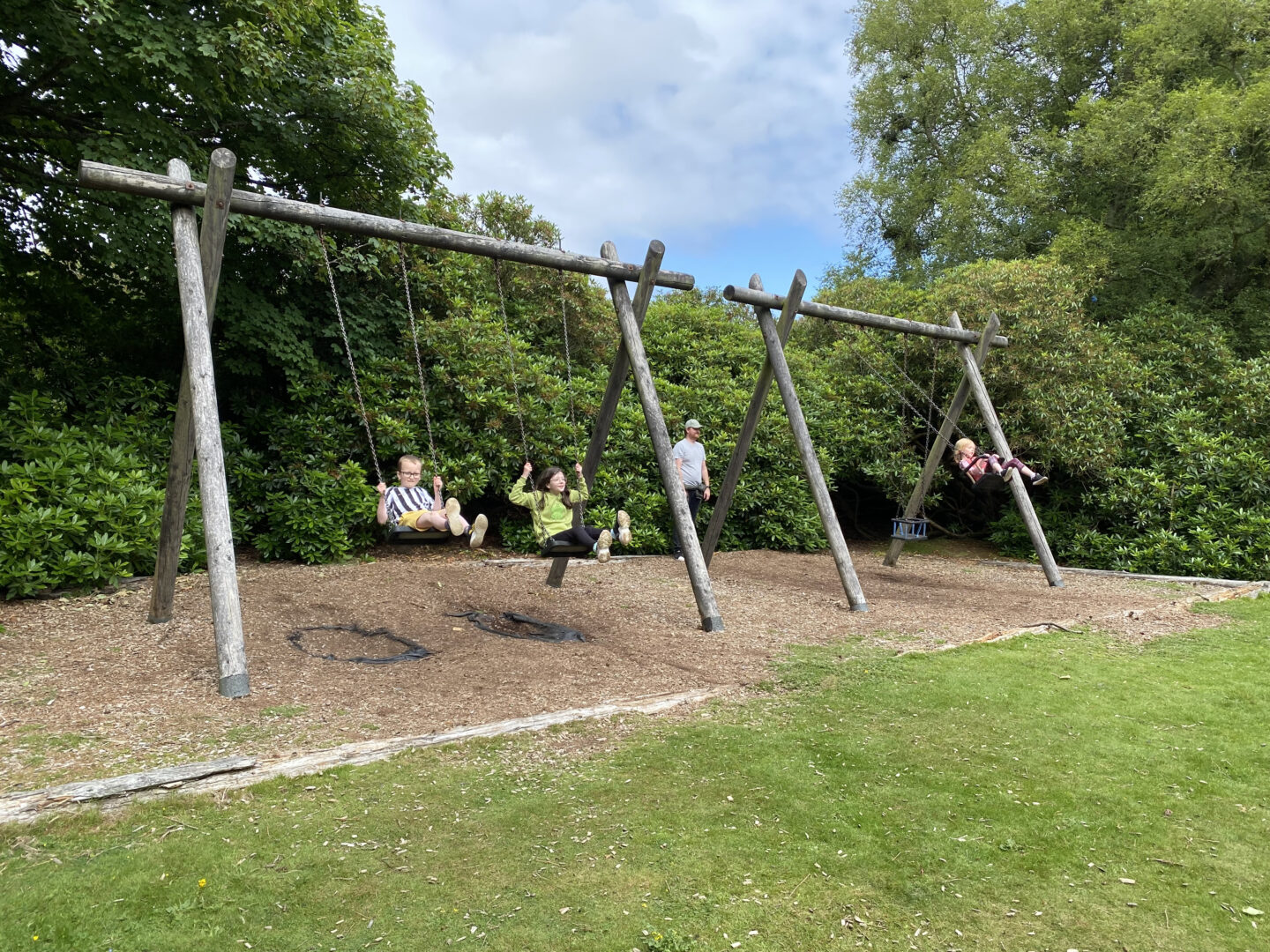 Children playing on the swings at Crombie Park