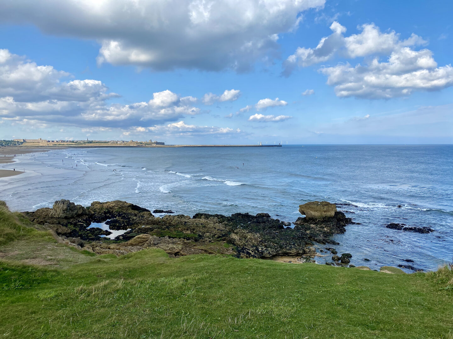 A cliff top overlooking a beach and the sea