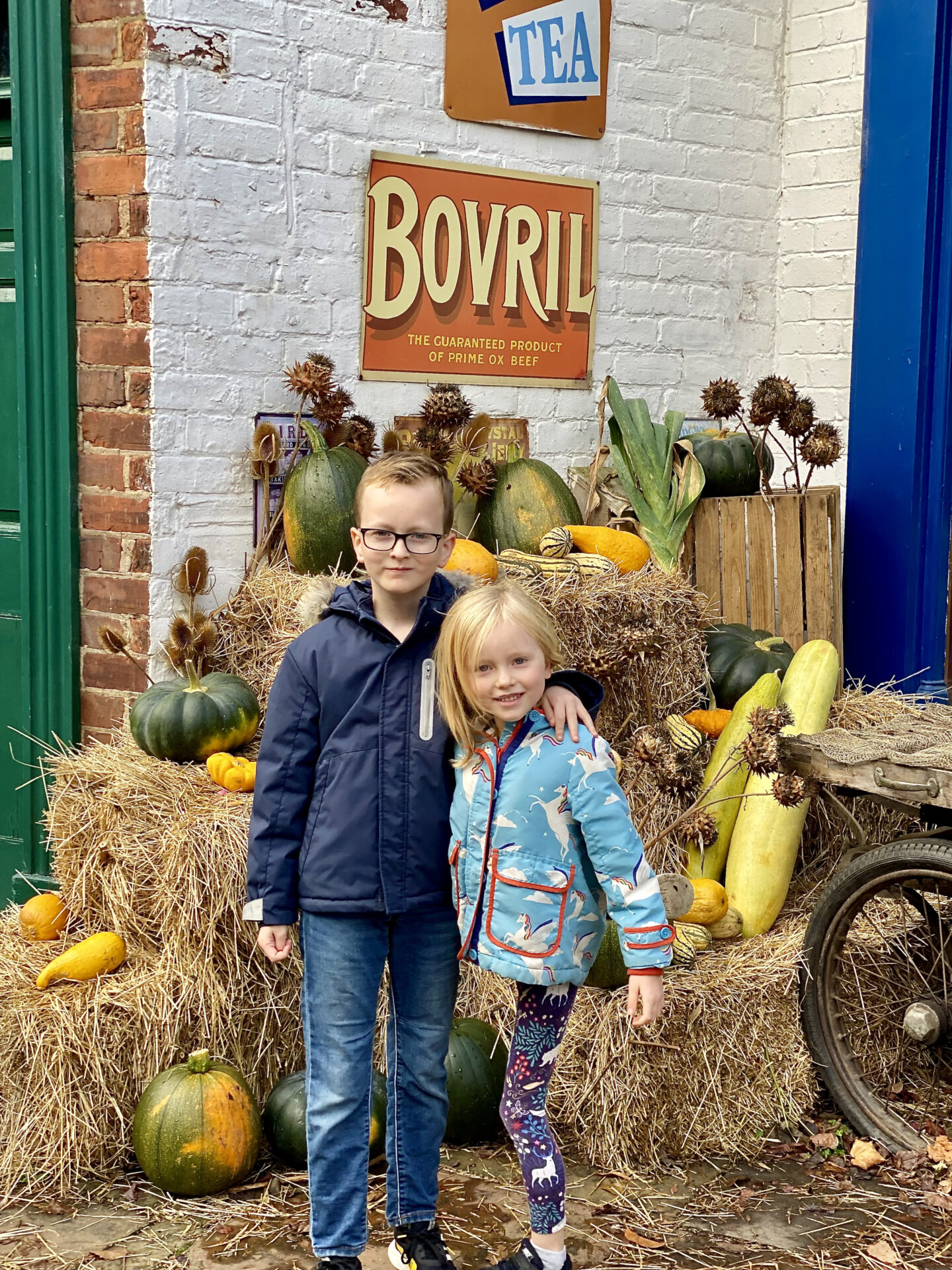 2 children smile in front of a display of pumpkins at Preston Park museum