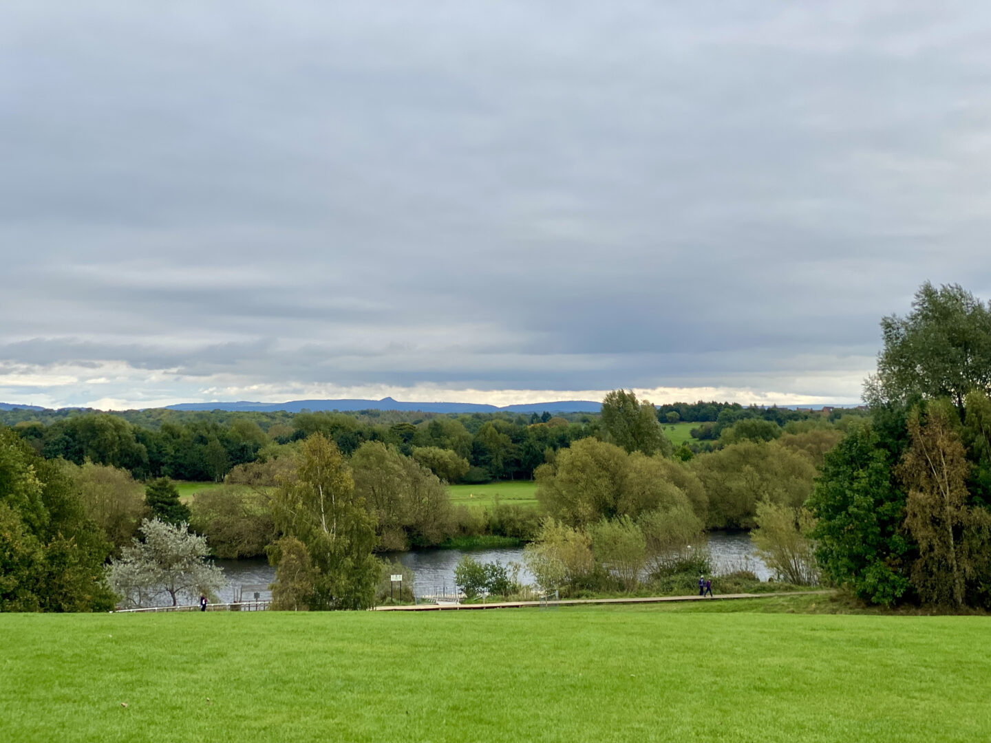 The grounds of Preston Park Museum - a large grass field overlooking trees and the river