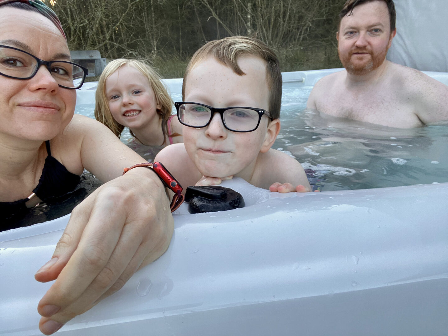 A family of 4 in a hot tub
