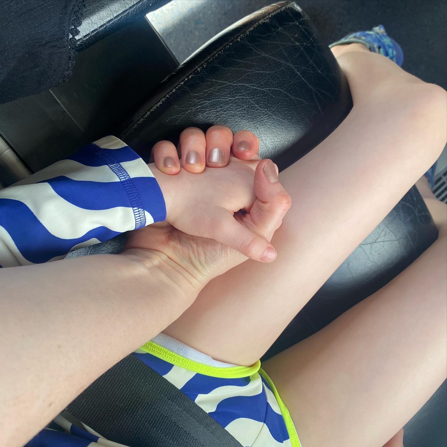 child holding mother's hand