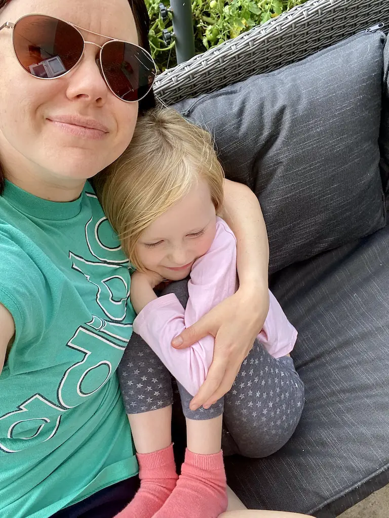 Mother and daughter hugging and looking happy