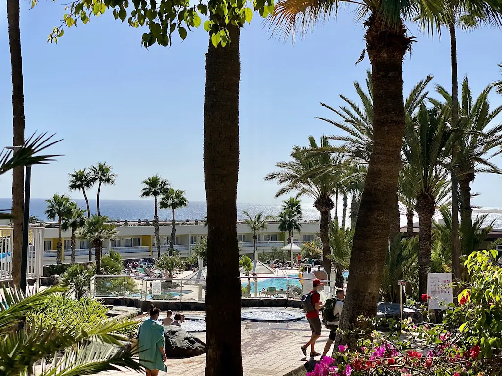 Palm trees, pools and a view of the beach