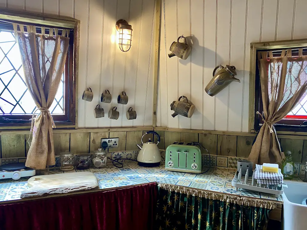 Kitchen with brown cups and jugs on the wall