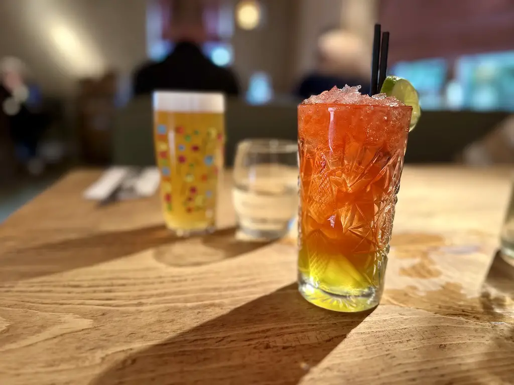 Drinks at the Smithy Runa Farm Barnard Castle - an orange and lemon tall cocktail and a pint of Neck Oil lager