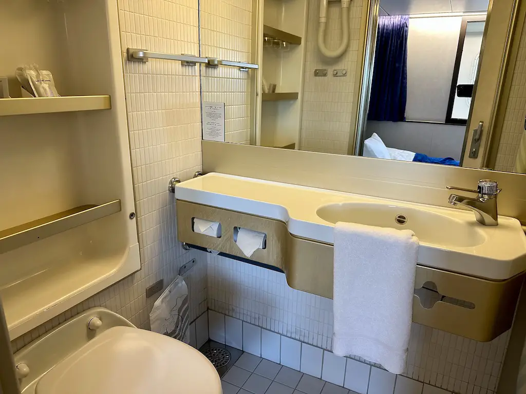 Plain cream basic commodore cabin bathroom on DFDS mini cruise