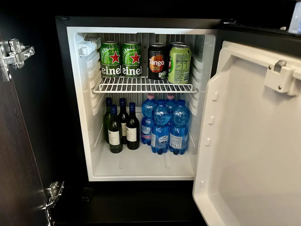 a mini fridge filled with water, soft drinks and alcohol in the commodore cabines on the DFDS mini cruise from Newcastle to Amsterdam