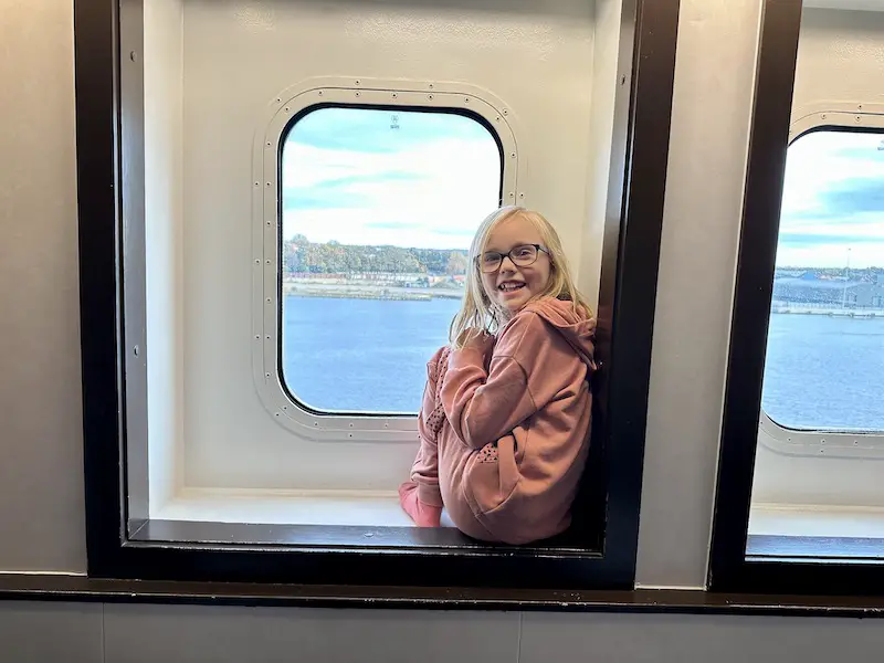 Little girl sits in window of a cabin on the DFDS Newcastle to Amsterdam ferry