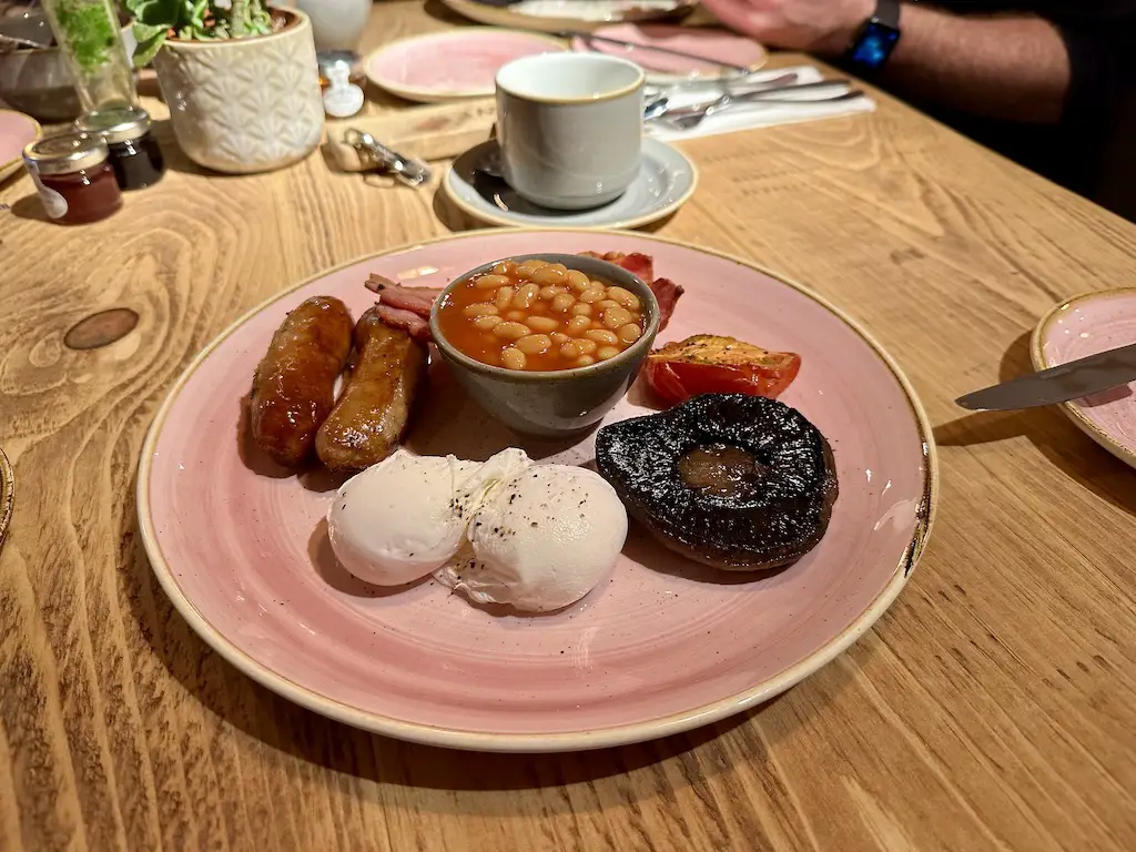 A cooked english breakfast on a pink glazed plate at Runa farm Barnard Castle