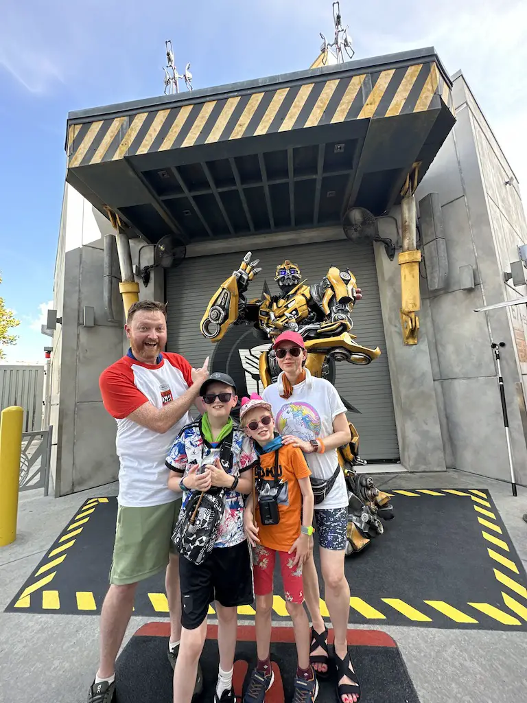 Family of 4 stands in fron of Bumblebee transformer - 2 week orlando itinerary 
