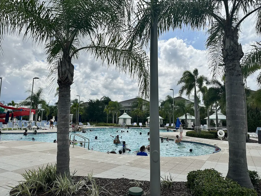 Encore resort pools - palm trees and a busy curved pool with cloudy skies