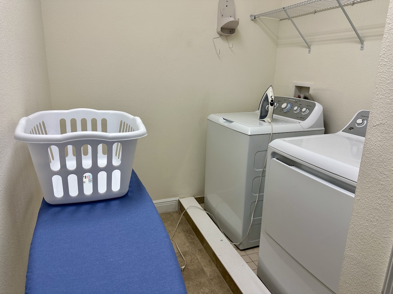 encore resort at reunion 5 bedroom villa laundry room with ironing board, washing basket, top loading washer and dryer