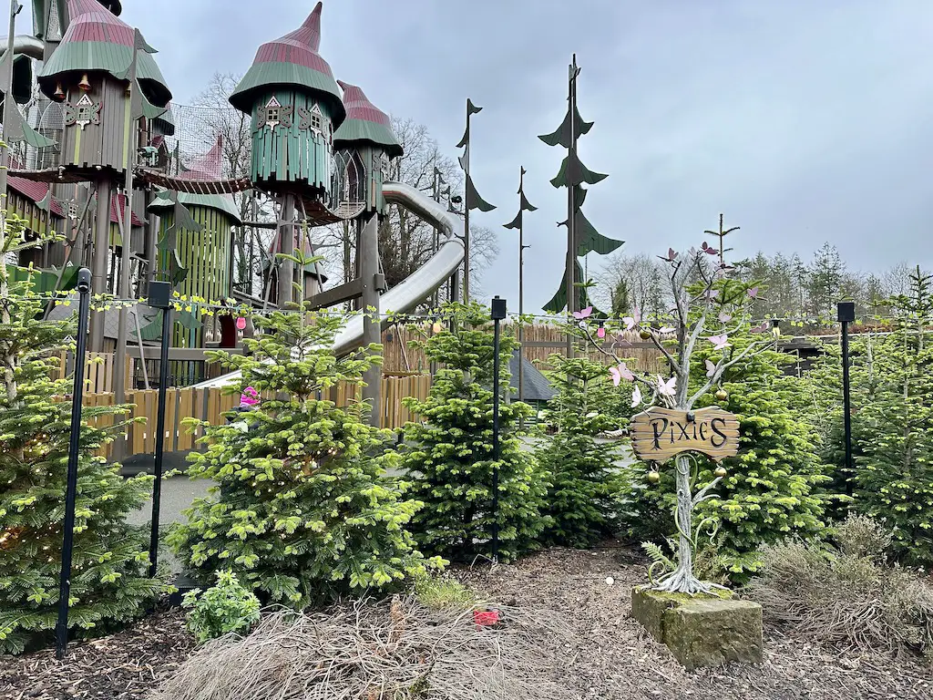 Christmas at Lilidorei pixie clan wooden sign with a play structure in the background