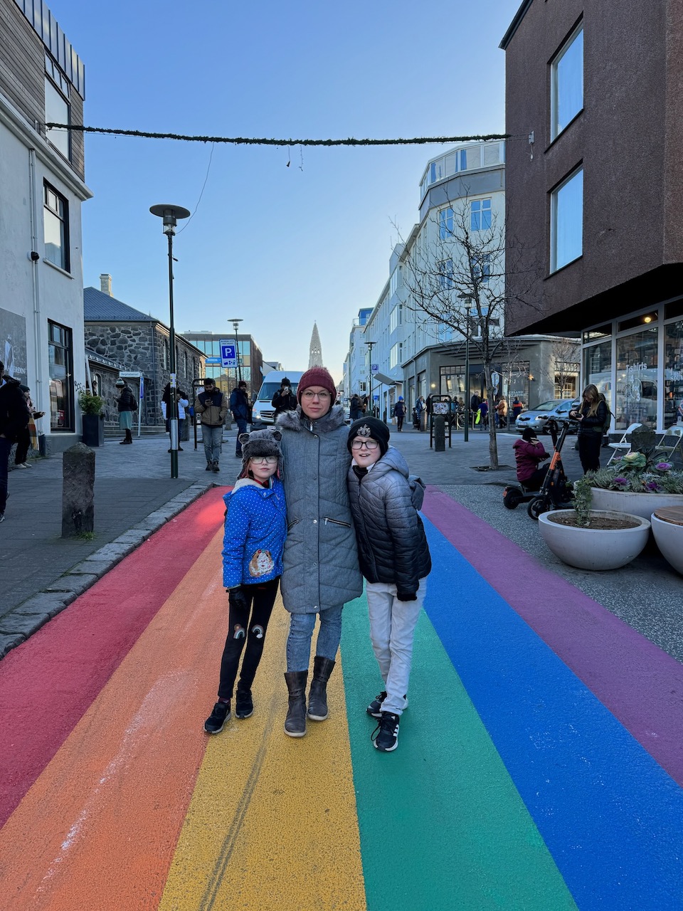 Iceland family holiday - family stood on the rainbow road